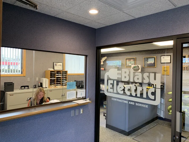 Inside the Blasy Electric office in Midland, with the company logo etched on the glass